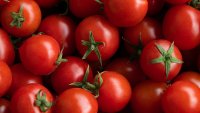 Ripe red cherry tomatoes at a retail market or hypermarket. Vegetarian, vegan and raw food and diet. Organic homemade farm products. Harvesting in the garden, vegetable garden, in the country. Food background. From the farm to the table. Vegetable food.