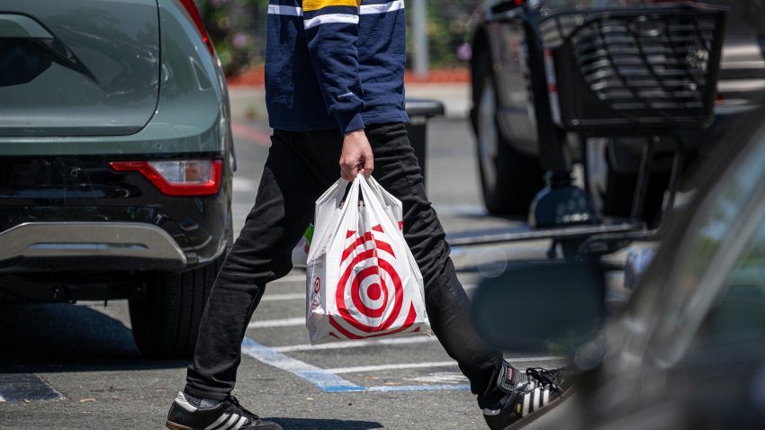 A shopper carries a shopping bag outside a Target store in Emeryville, California, US, on Tuesday, May 20, 2025.