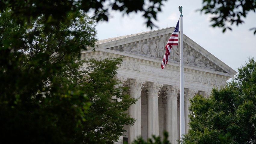 FILE – An American flag waves in front of the U.S. Supreme Court building in Washington, June 27, 2022.