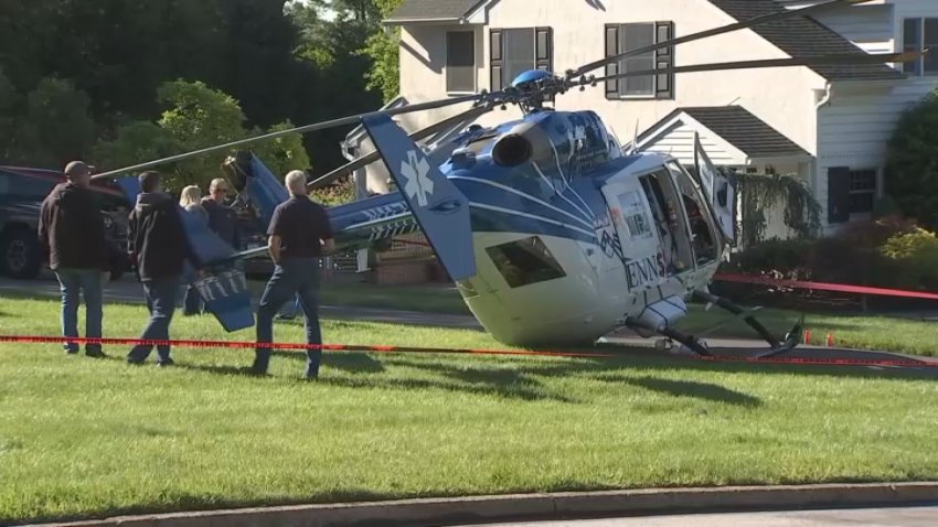 Investigators inspect the wreckage after a helicopter made an emergency landing in Montgomery County on Monday.