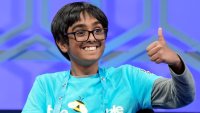 Faizan Zaki, 12, of Allen, Texas, gestures to his family after spelling his word correctly in the finals of the Scripps National Spelling Bee, in Oxon Hill, Md., May 30, 2024. (AP Photo/Mariam Zuhaib, File)