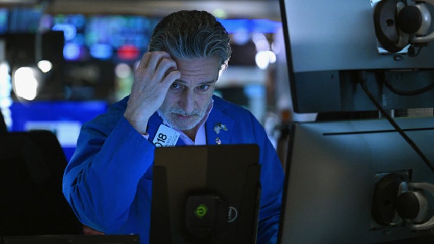 Traders work on the floor during morning trading at the New York Stock Exchange.