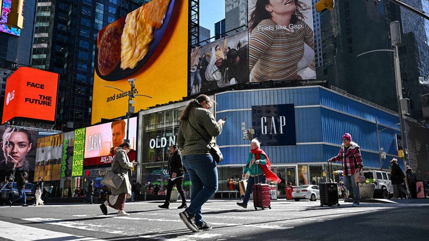 Old Navy and Gap retail stores are seen as people walk through Times Square in New York City on April 9, 2025.