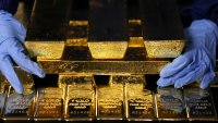 An employee arranges gold bars at the Italpreziosi SpA precious metals refinery plant in Arezzo, Italy, on Tuesday, May 6, 2025.