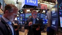 Traders work on the floor at the New York Stock Exchange (NYSE) in New York City, U.S., June 25, 2025.