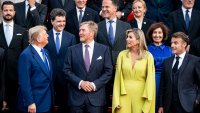 US President Donald Trump, left, talks with secretary general of NATO Mark Rutte, center, during a family photo at the 2025 NATO summit in The Hague, on Tuesday, June 24, 2025. (Haiyun Jiang/Pool Photo via AP)