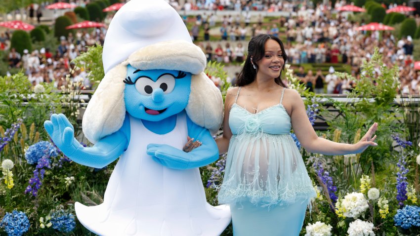 Rihanna poses with a person in a Smurfette costume for photographers upon arrival at the world premiere of the film “Smurfs”, on Saturday, June 28, 2025, in Brussels.