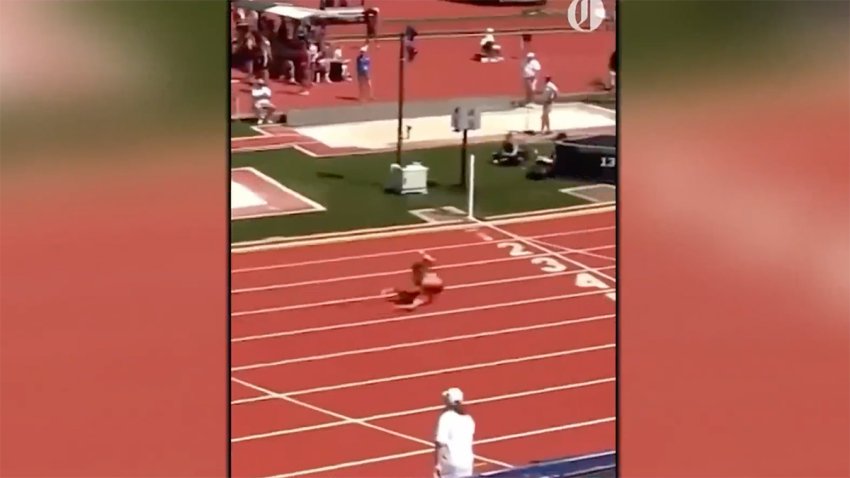 This screenshot from a video shows high school athlete Brooklyn Anderson somersaulting to a 1st place finish.