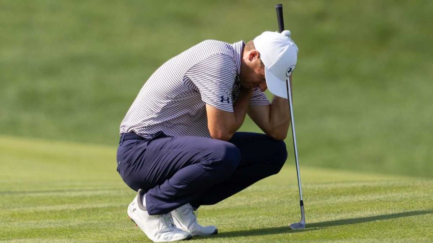 Jun 19, 2025; Cromwell, Connecticut, USA; Jordan Spieth crouches while grabbing his upper body on the 12th hole during the first round of the Travelers Championship golf tournament.