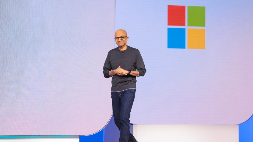 Microsoft Chairman and Chief Executive Officer Satya Nadella (L) returns to the stage after a pre-recorded interview during the Microsoft Build conference opening keynote in Seattle, Washington on May 19, 2025.