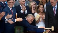US President Donald Trump bangs a gavel after signing his signature bill of tax breaks and spending cuts “Big Beautiful Bill” on the South Lawn of the White House in Washington, DC, on July 4, 2025.