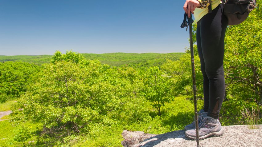 a female hiker on top of a mountain summit
