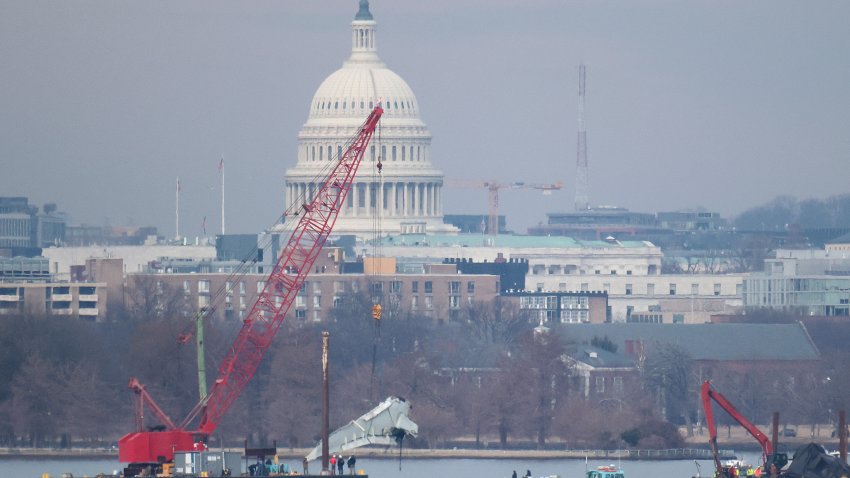 A crane lifts a piece of American Airlines flight 5342 from the Potomac River during recovery efforts on February 03, 2025 in Arlington, Virginia. An American Airlines flight from Wichita, Kansas collided midair with a military Black Hawk helicopter while on approach to Ronald Reagan Washington National Airport on January 29, 2025 outside of Washington, DC. According to reports, there were no survivors among the 67 people onboard both aircraft. (Photo by Win McNamee/Getty Images)