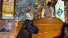 A black lab carved into a wooden pew is pictured in the Dog Chapel at Dog Mountain, a 150-acre dog park created by Vermont folk artist Stephen Huneck, Thursday, Aug. 7, 2025, in St. Johnsbury, Vt.
