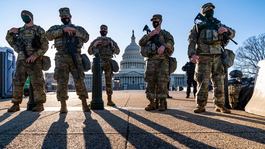 FILE - National Guard troops and the U.S. Capitol Police keep watch amid heightened security around the Capitol grounds in Washington, March 3, 2021.