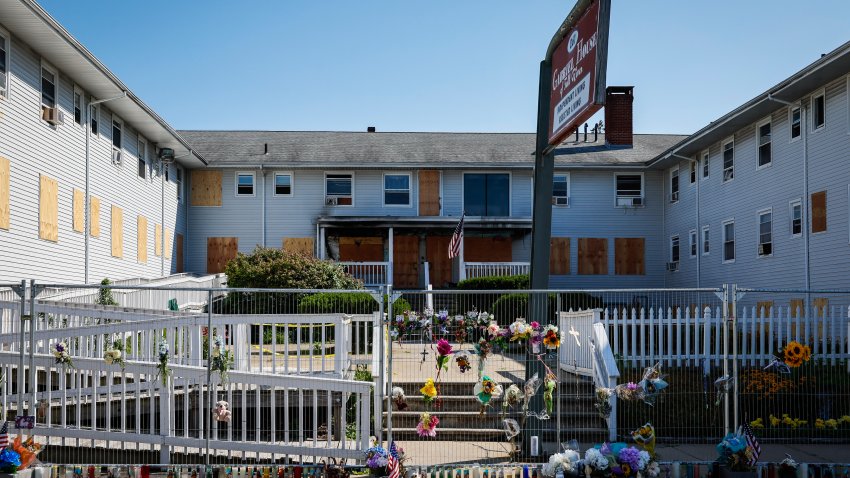 Fall River, MA – July 23: Flowers, photographs and memorial items are placed along the chain-link fence surrounding Gabriel House assisted living facility on July 23, 2025. (Photo by Erin Clark/The Boston Globe via Getty Images)