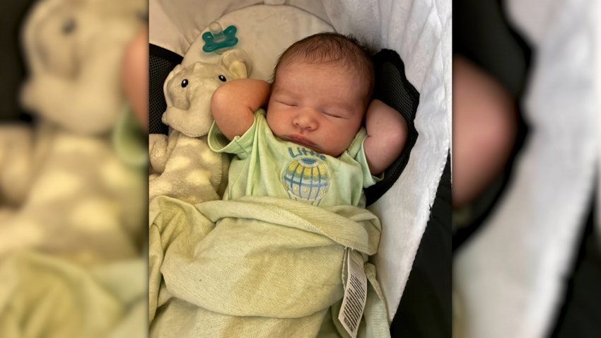 Vincent Smith, an infant born on Christmas following a so-called 'cryptic pregnancy,' is pictured swaddled in a blanket and pajamas.