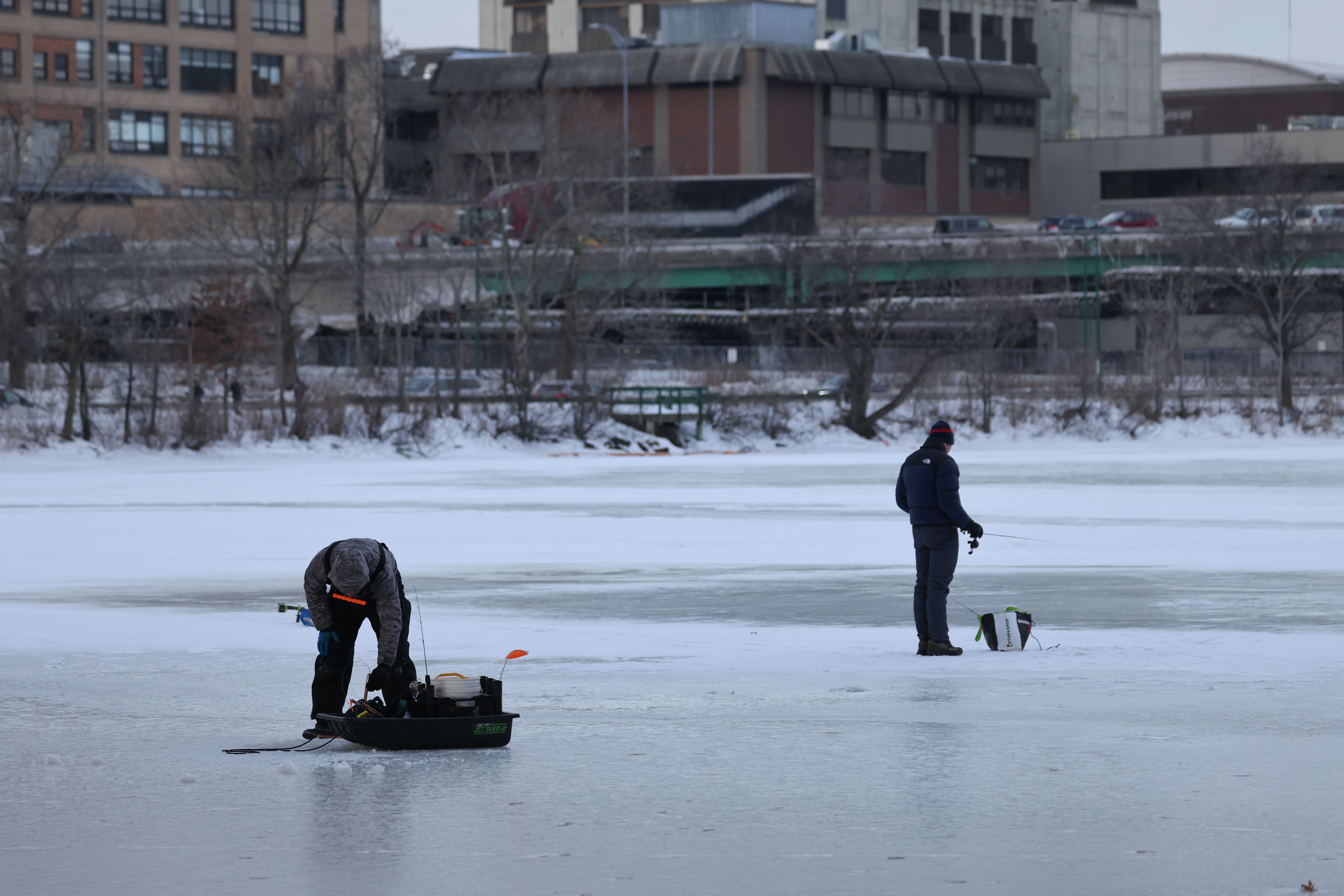 Ice fisherman on the frozen Charles River near BU Bridge between Boston and Cambridge on Friday, Feb. 6, 2026. A Massachusetts state trooper was called to talk to people out on the ice.
