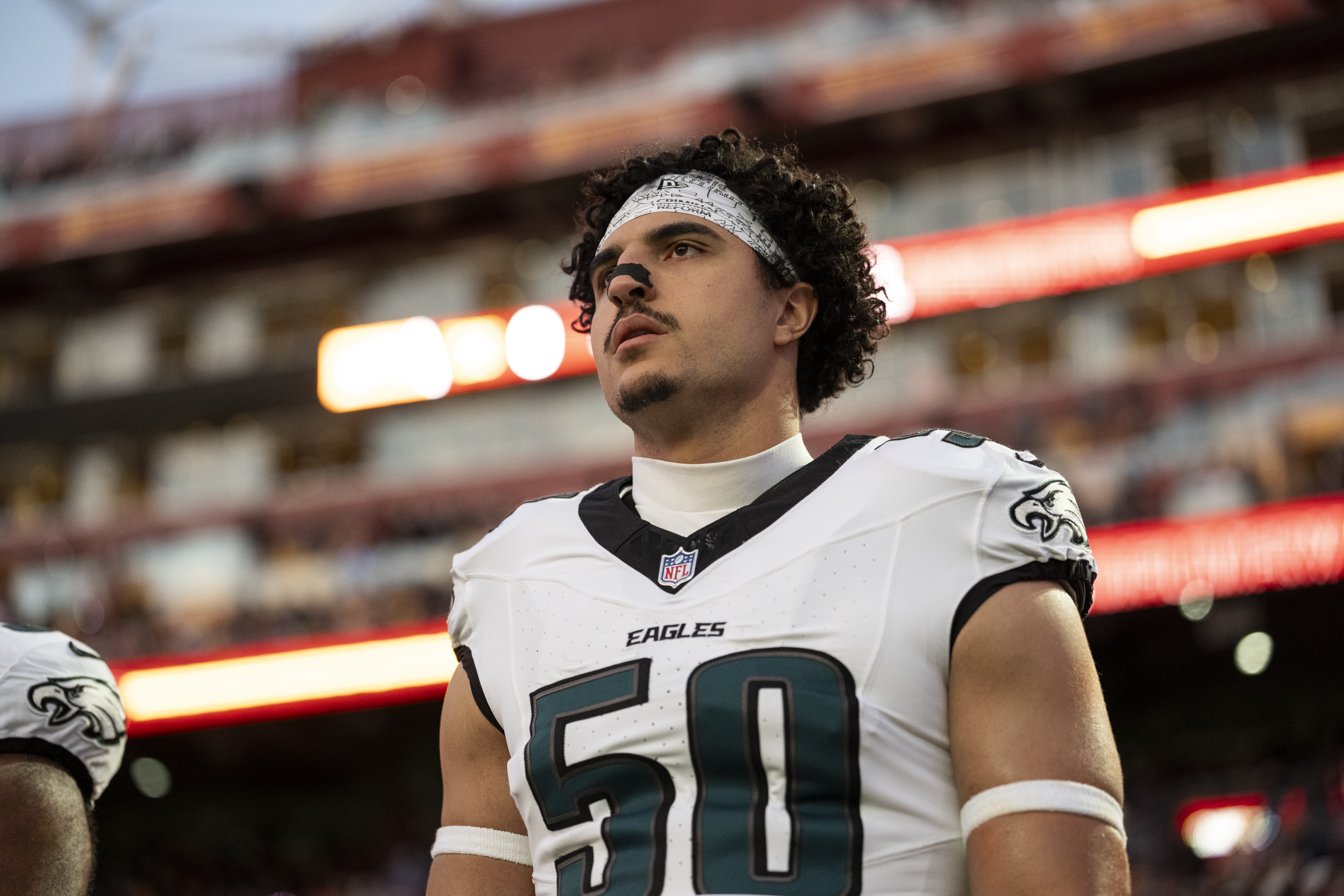 LANDOVER, MARYLAND – DECEMBER 20: Jaelan Phillips #50 of the Philadelphia Eagles looks on during the national anthem prior to an NFL football game against the Washington Commanders at Northwest Stadium on December 20, 2025 in Landover, Maryland. (Photo by Michael Owens/Getty Images)