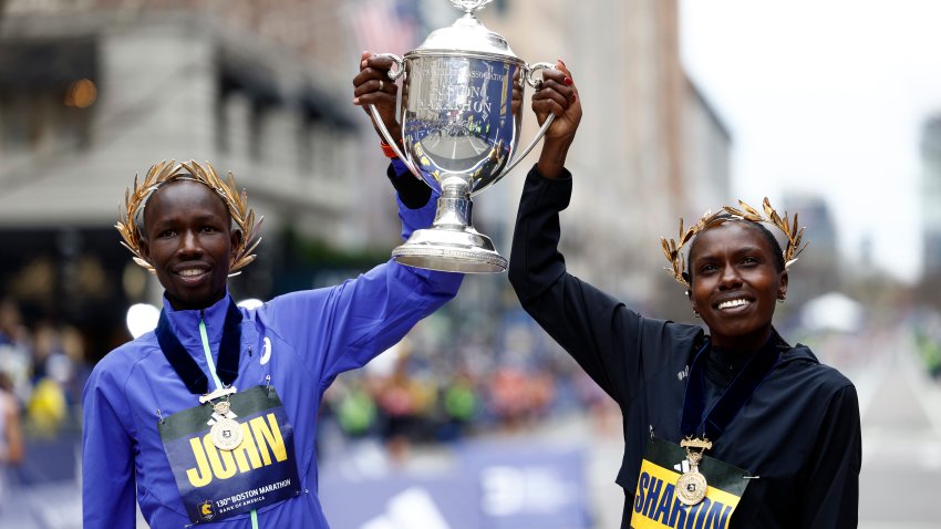 Boston, MA – April 20: John Korir and Sharon Lokedi pose with the trophy after winning the 130th Boston Marathon on April 20, 2026. (Photo by Danielle Parhizkaran/The Boston Globe via Getty Images)
