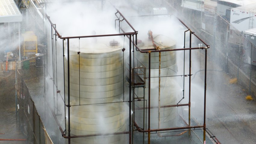 An aerial of water being sprayed on large storage tanks at the GKN Aerospace facility on Sunday, May 24, 2026, in Garden Grove, CA.