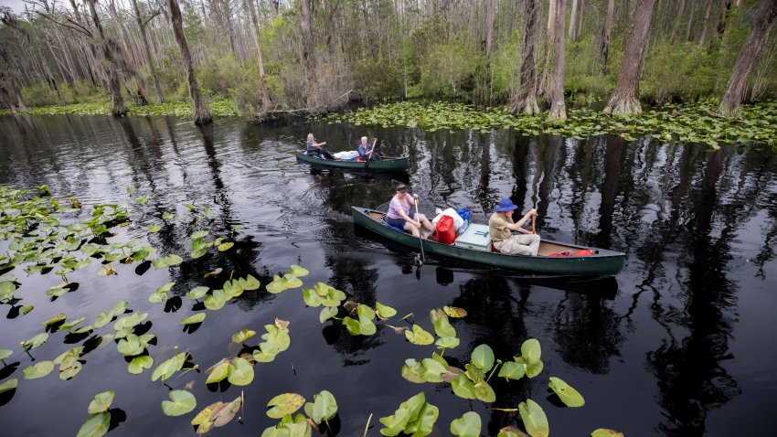 Visitors return to Stephen C. Foster State Park after an overnight camping trip on the Red Trail in the Okefenokee National Wildlife Refuge in Fargo, Ga., April 6, 2022. (AP Photo/Stephen B. Morton)
