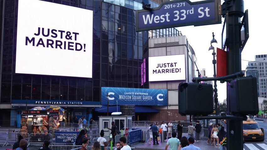 Giant screens showing the message "JUST&T MARRIED!" (T&T for Taylor and Travis) are seen outside Madison Square Garden, the reported venue for the wedding celebrations of pop singer Taylor Swift and pro-athlete Travis Kelce, in New York Cit