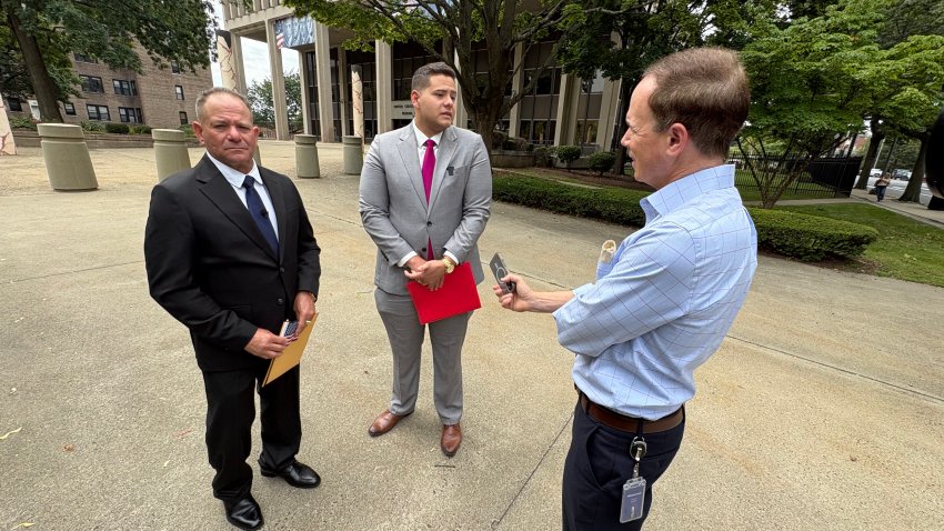 Moises Ricardo of Bristol talks with NBC Connecticut investigative reporter Len Besthoff, flanked by his son Marlon Ricardo Comejo