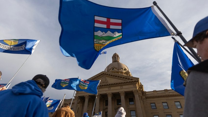 People fly flags during an Alberta Independence Rally in Edmonton, Alberta, Canada on October 17, 2026. Alberta voters decide next week if they want the oil-rich province to begin the process of separating from Canada, a pivotal test for the country as it confronts a hostile United States.