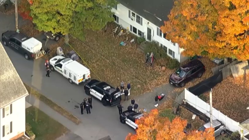 Police outside the home in Reading, Massachusetts, where Andria Hanafin was found dead early on Thursday, Oct. 8, 2026.